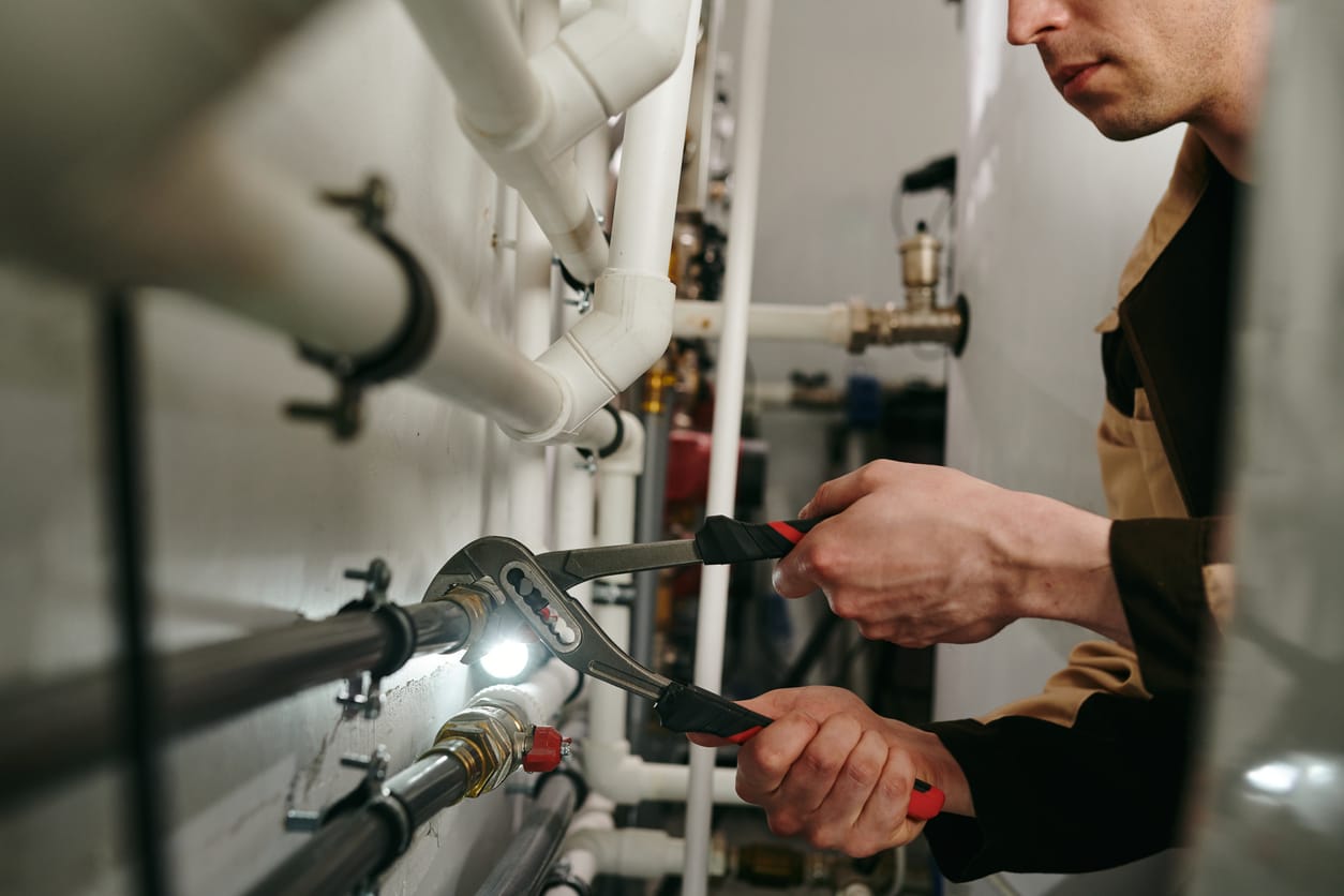 Plumbers maintaining commercial plumbing pipes in Kennesaw