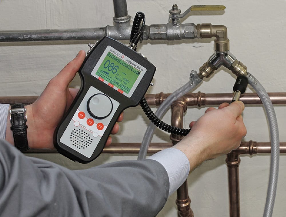 Plumber testing pipes with electronic leak detection equipment in Kennesaw