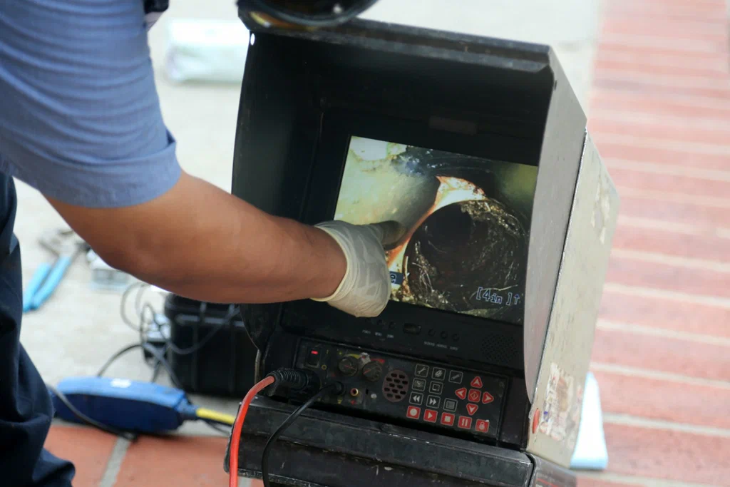 Technician viewing a drain inspection camera in Kennesaw