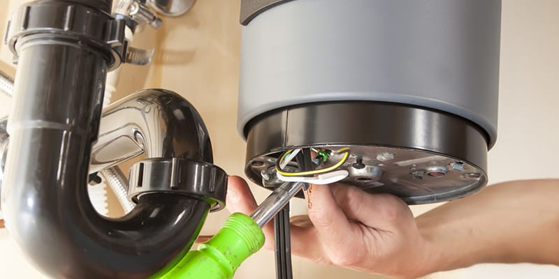 Technician repairing the heating element of a water heater in Kennesaw