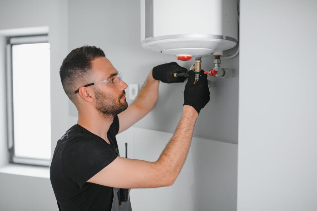 Technician performing water heater maintenance in Kennesaw
